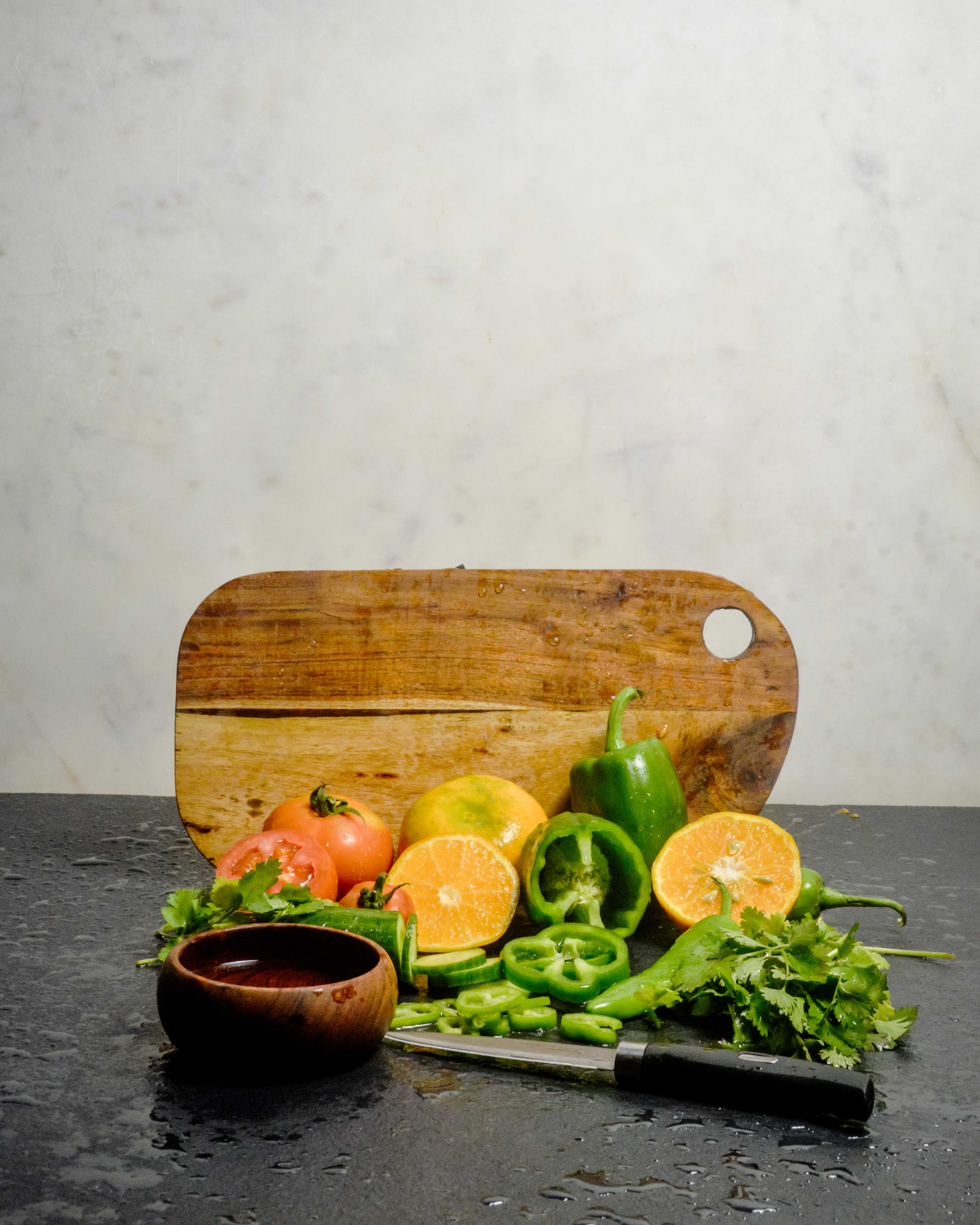 Sustainable wooden chopping board with fresh vegetables - kitchen cutting board for meal preparation and serving