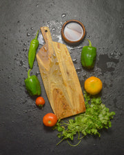 Handcrafted acacia wood chopping board with fresh vegetables - artisan kitchen cutting board by Marbique