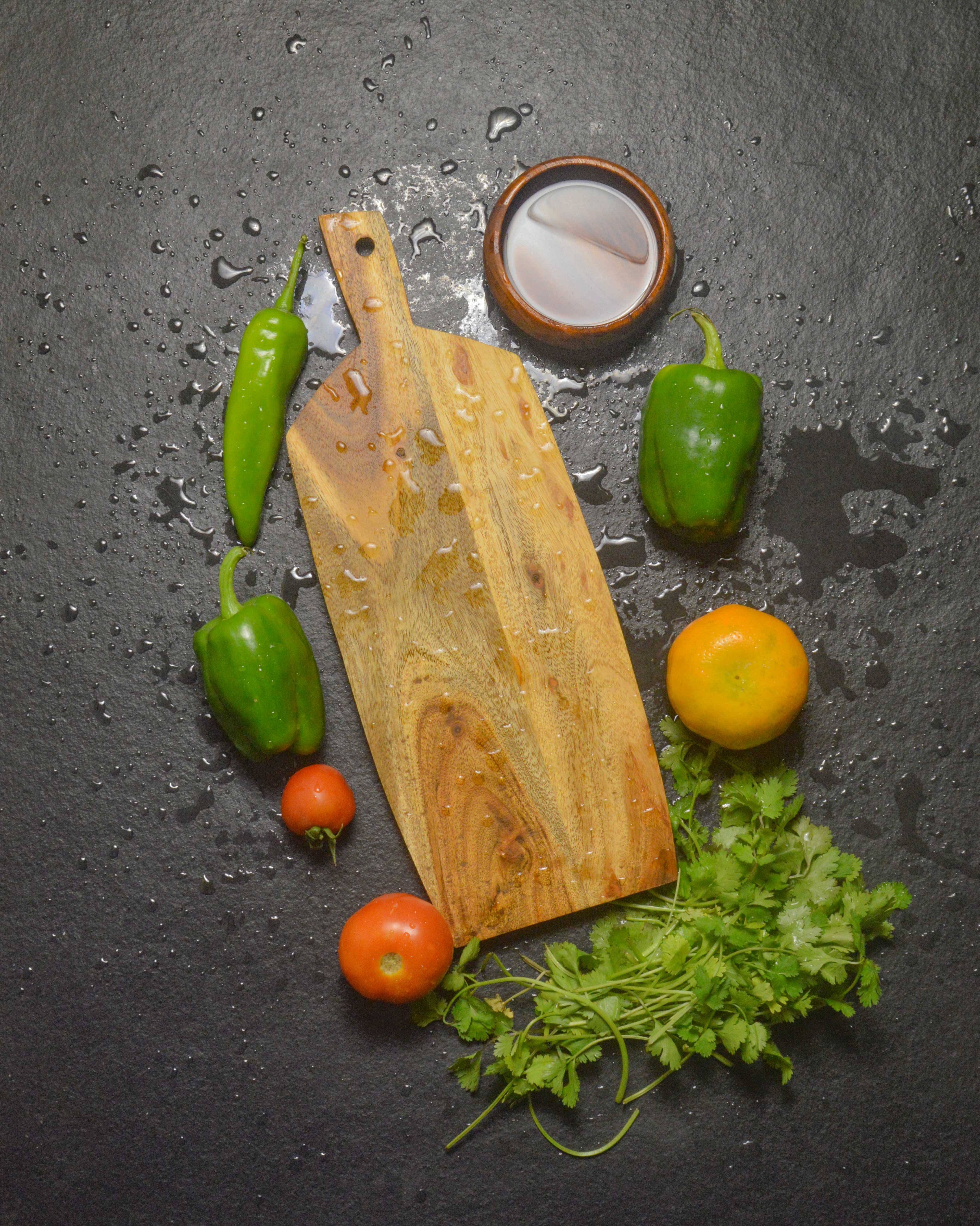 Handcrafted acacia wood chopping board with fresh vegetables - artisan kitchen cutting board by Marbique