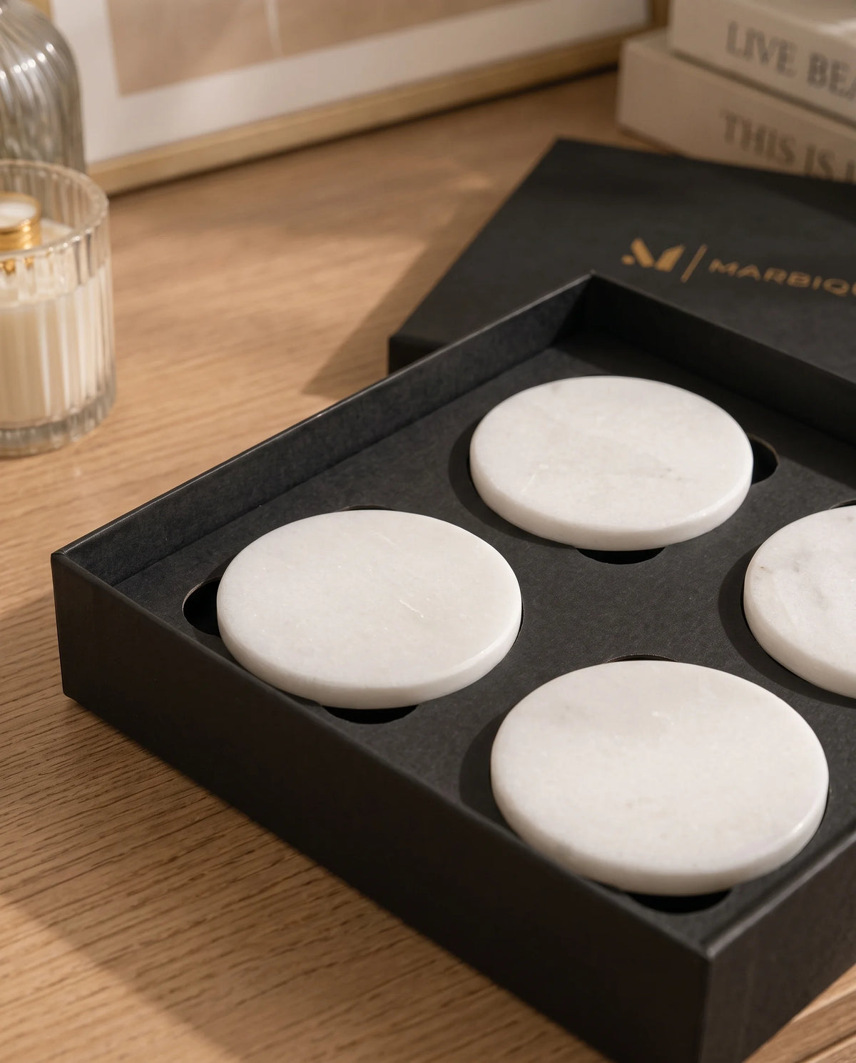 White circular coasters with plain surfaces styled with a drink.