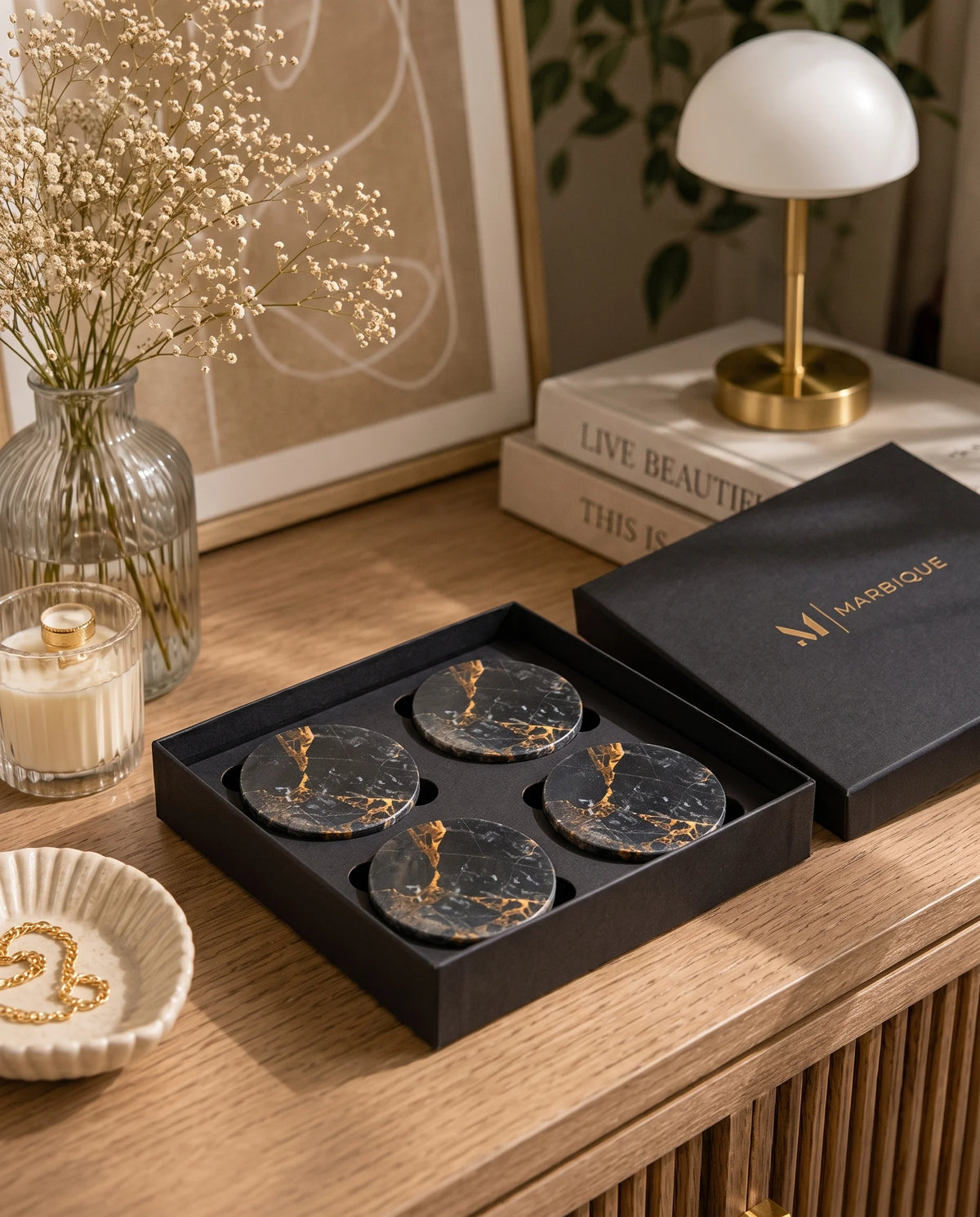 Dark circular coasters with warm branching veins styled with drinkware.