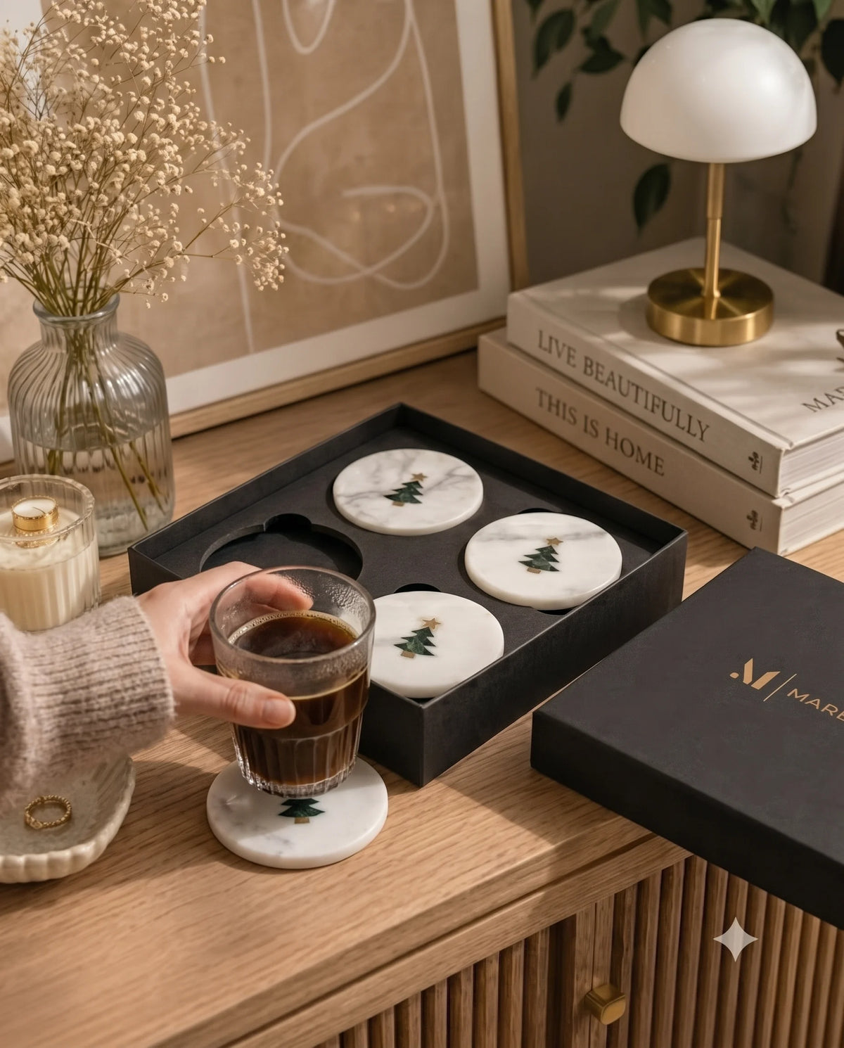 White Christmas tree coaster designs styled with a drink on a table.