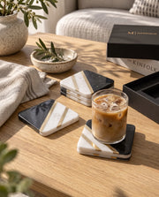 Black and white square coaster design with pale speckling and diagonal gold-tone strips.