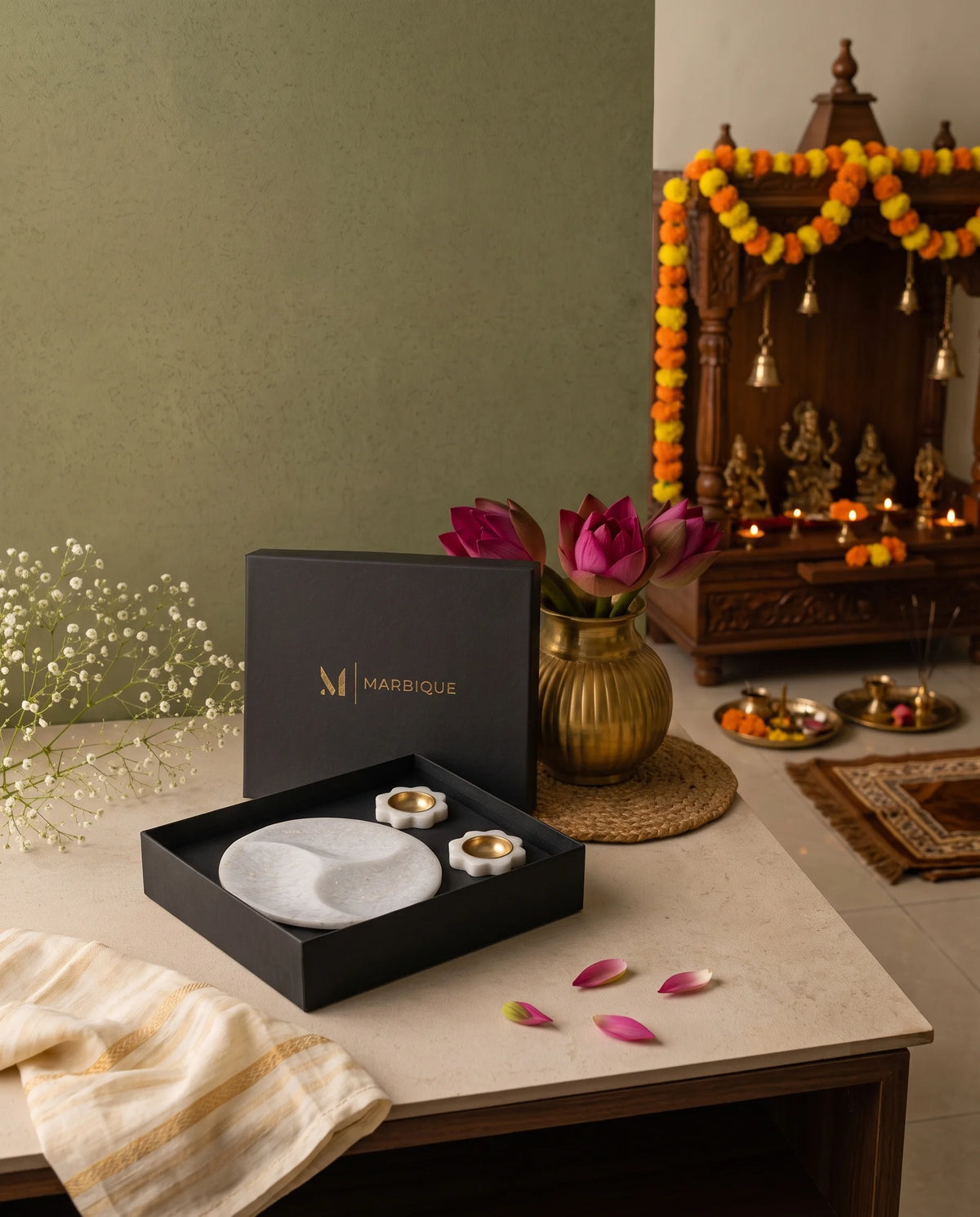 White divided round tray and floral holders photographed from above in a black presentation box.