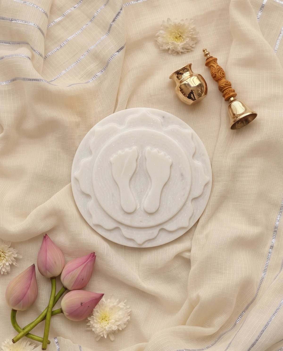 Overhead view of the round white footprint plaque with a petal-like middle layer.