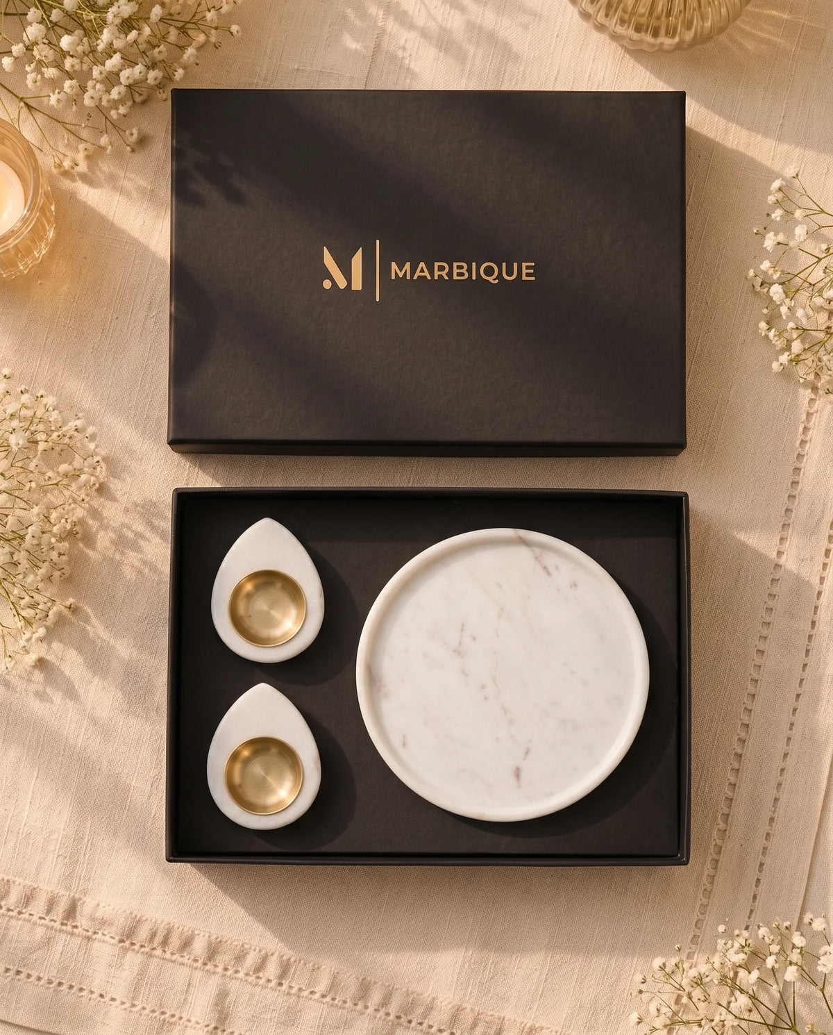 Close-up of the raised dish edge and white teardrop holders with gold-tone cups.