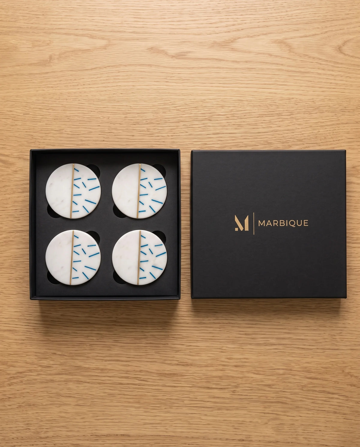 Round white coaster designs combining a plain section with blue dash marks and a gold-tone divider.