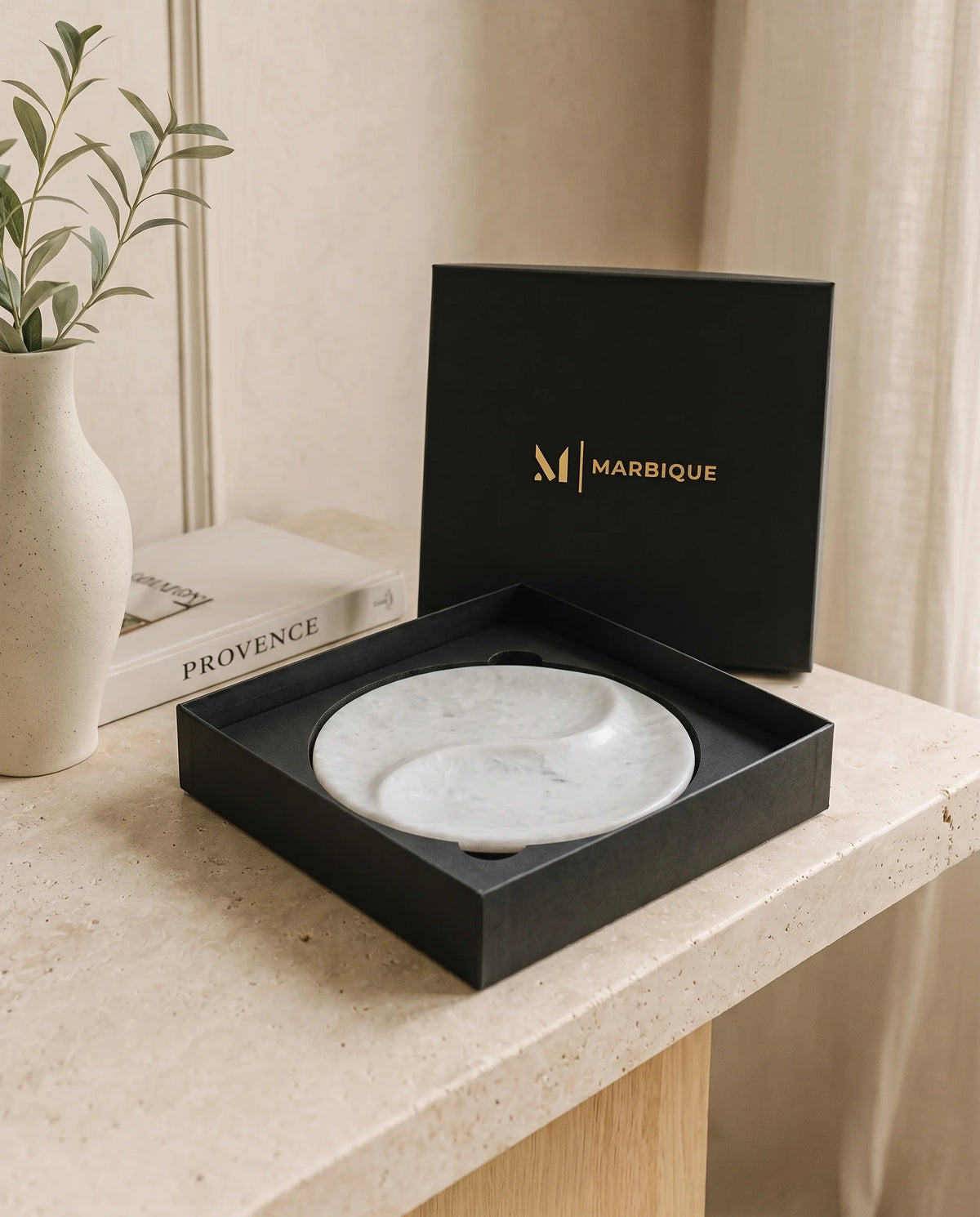White circular tray showing the flowing divider between its two recessed sections.
