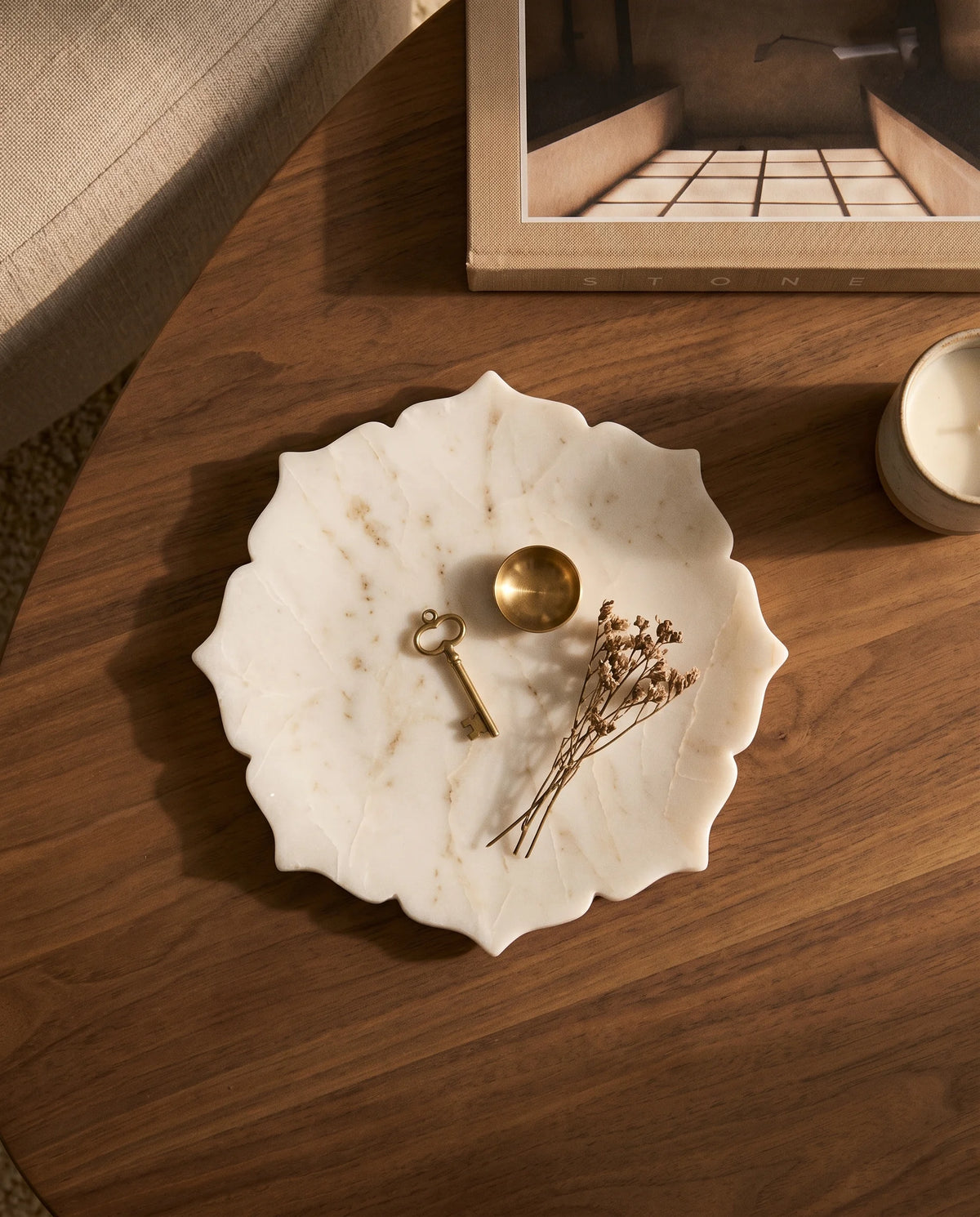 Close view of pale veining across the white scalloped round tray.