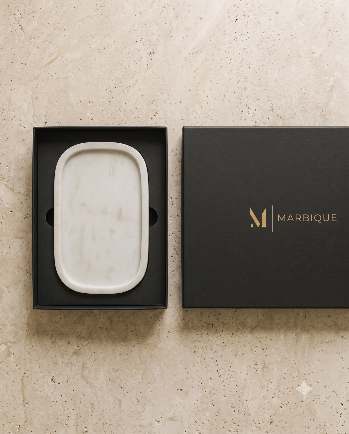 White rounded-corner tray displayed with black Marbique presentation packaging.
