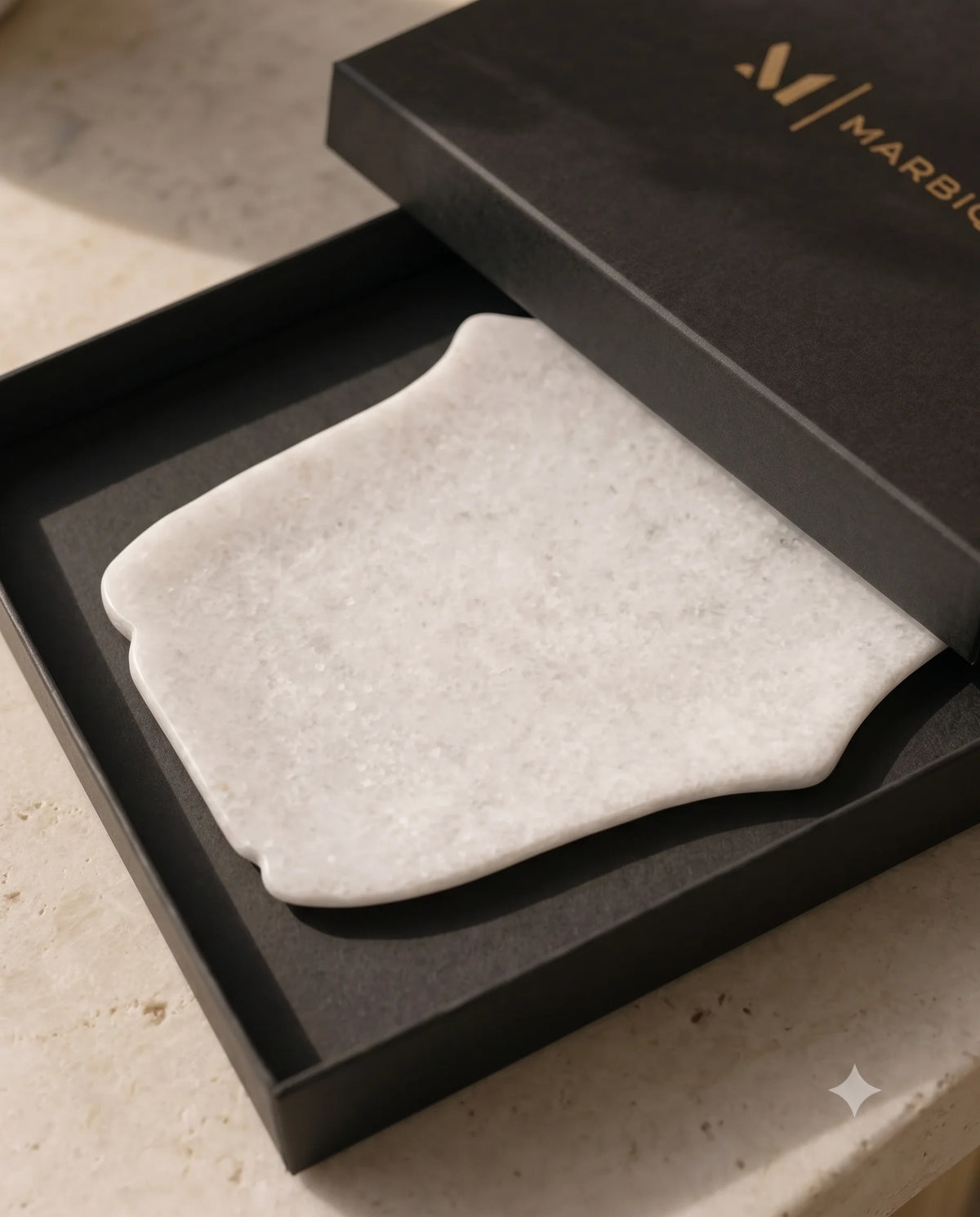 White decorative tray showing curved sides, broad ends and pale veining.