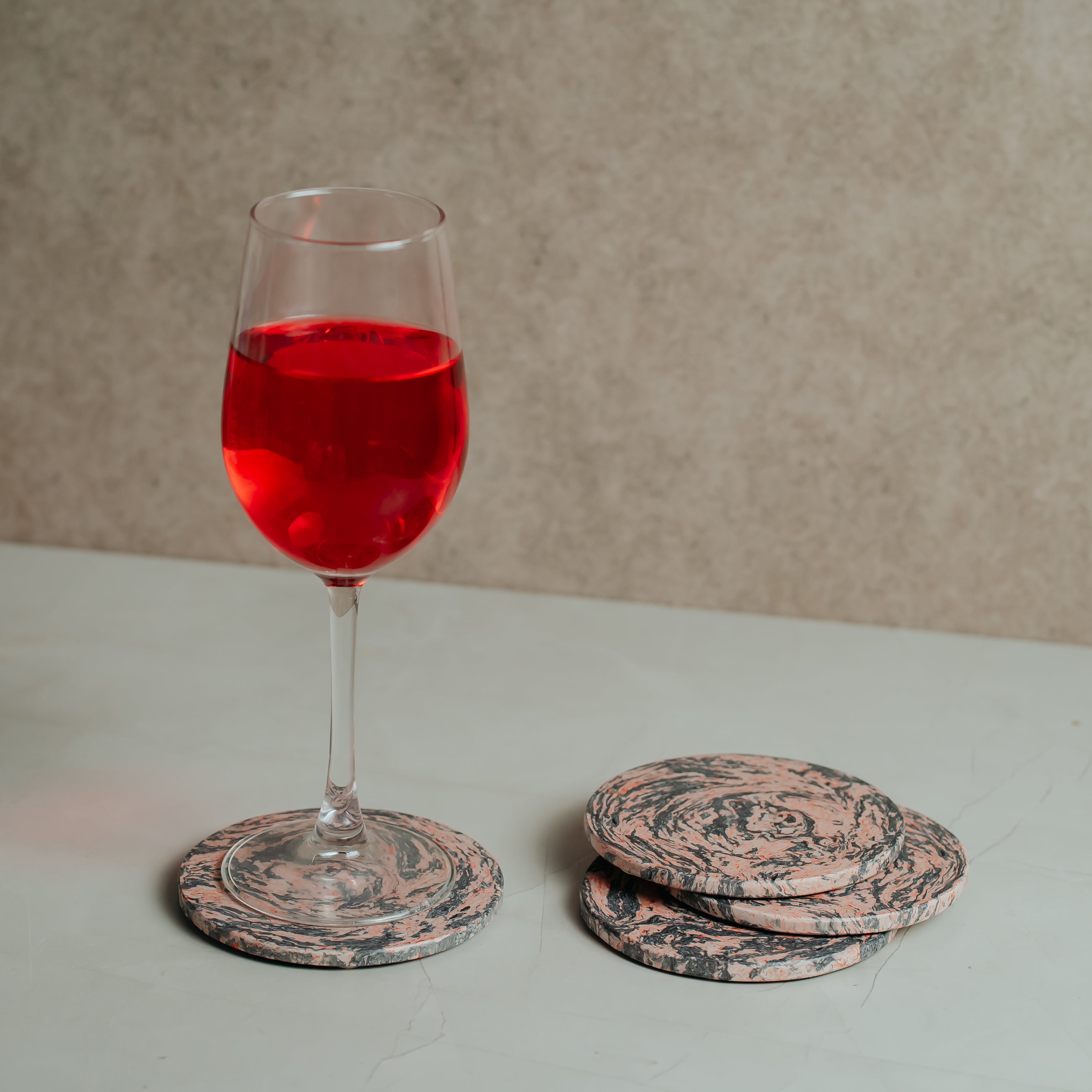 Marble resin coaster protecting furniture from red wine glass stains