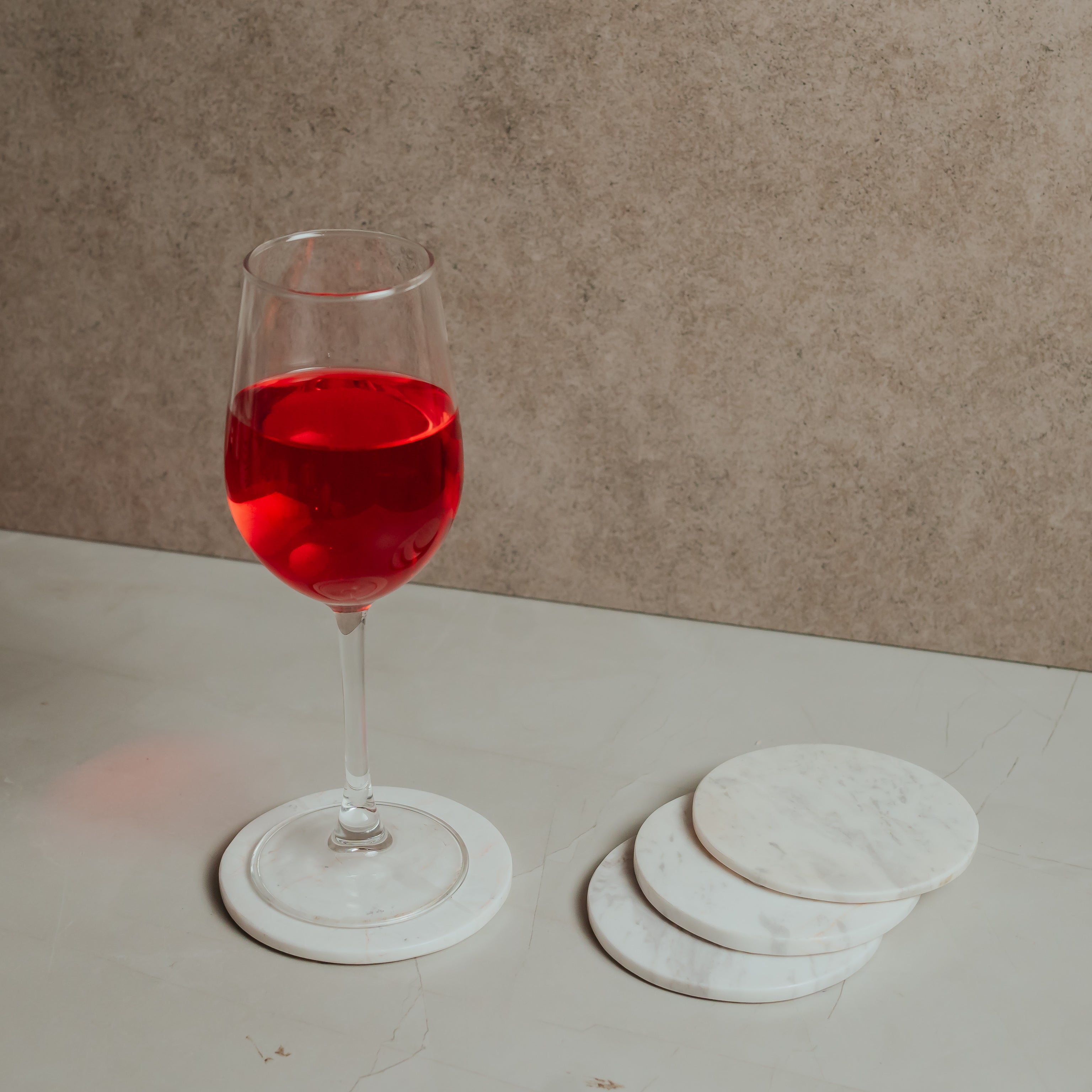 Luxury white marble coasters protecting table surface from red wine glass stain functional design