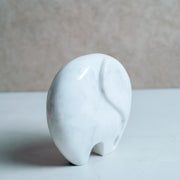 Majestic hand-carved white marble elephant sculpture with intricate trunk detail side profile view