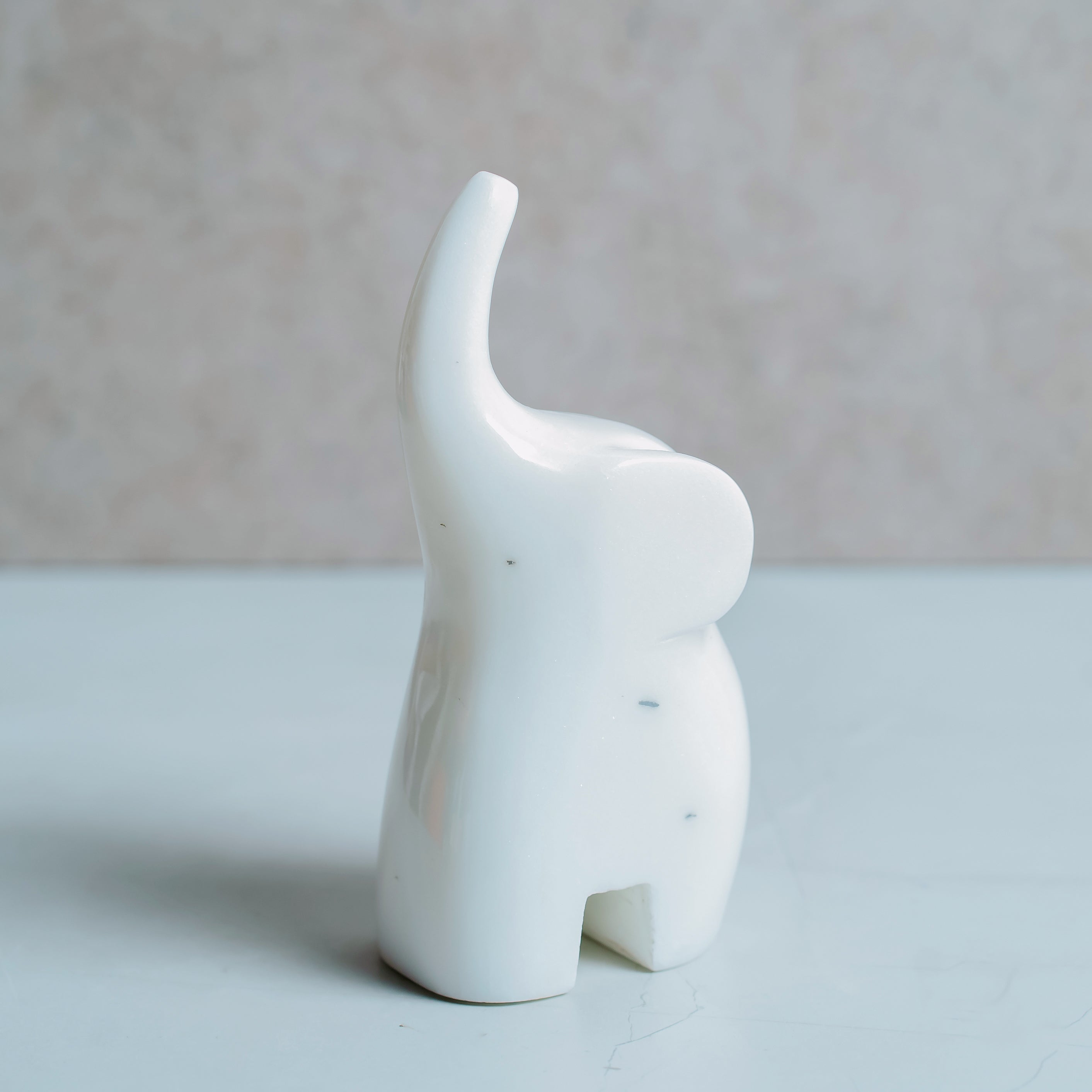 Elegant white marble elephant statue - hand-carved sculptural art piece for modern interior design