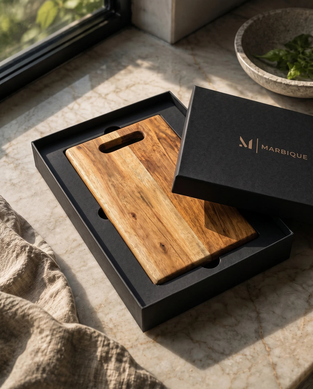 Brown rectangular slotted-grip board in an open black Marbique box with the lid partly over it.